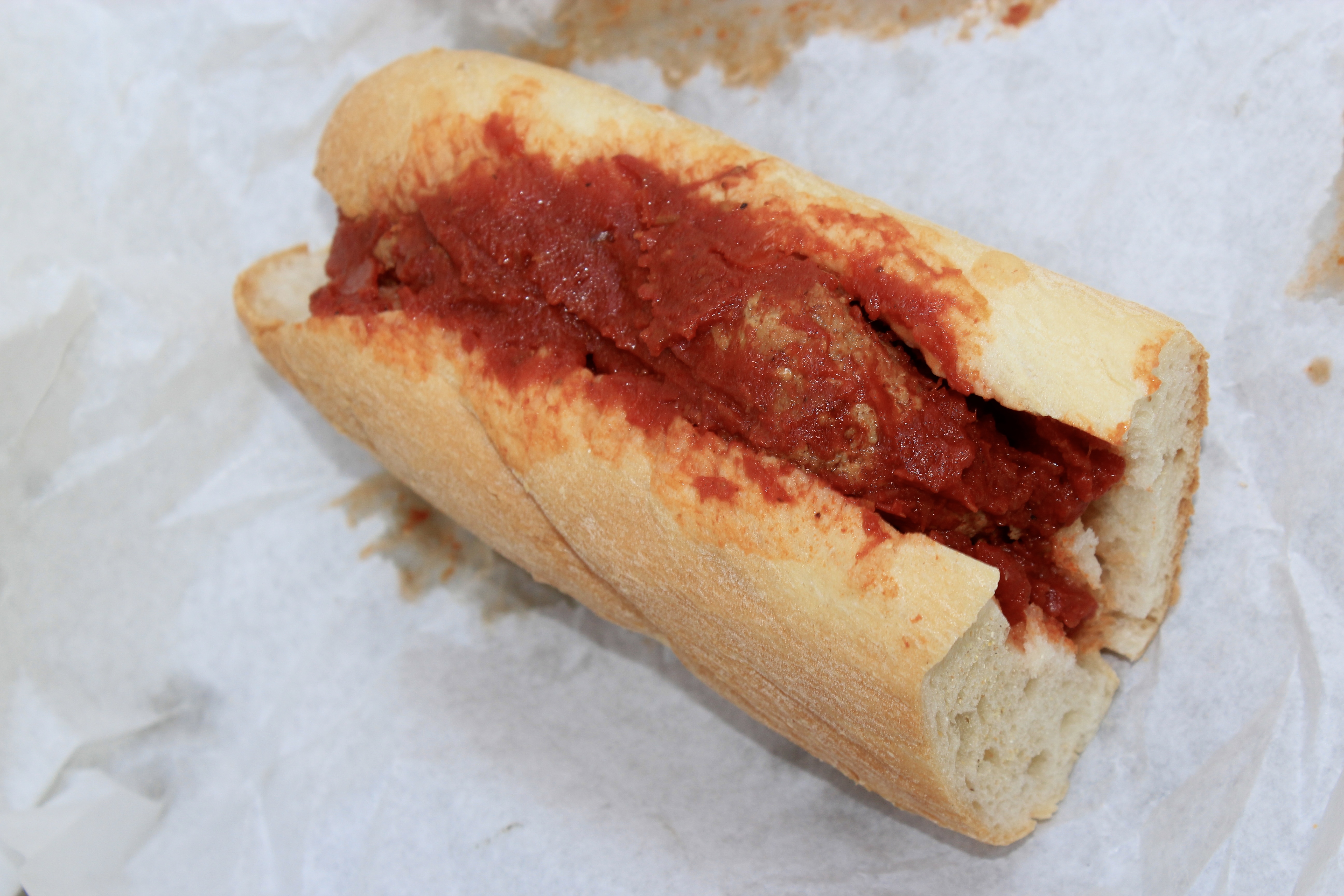 Homemade Italian meatball sandwich covered in marinara on fresh French bread